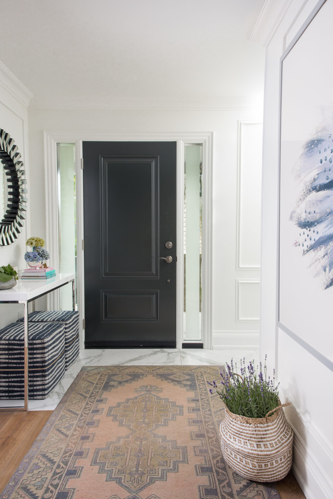 Mid-sized transitional entry hall in Toronto with white walls, marble floors, a single front door, a black front door and white floor.