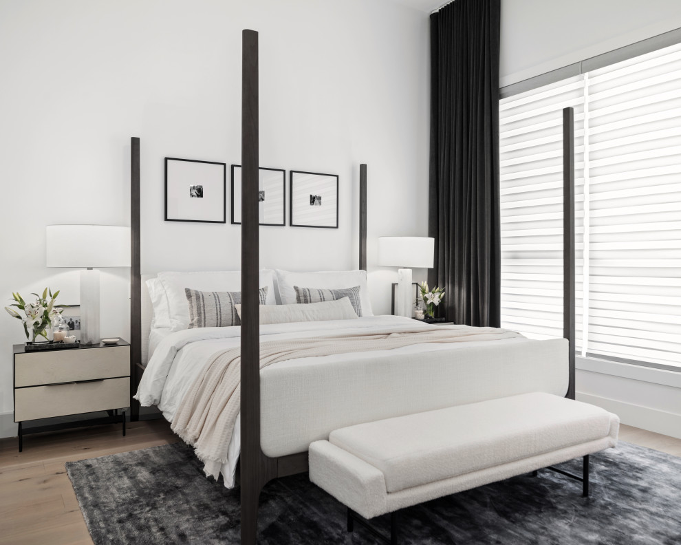 Design ideas for a mid-sized modern master bedroom in Calgary with white walls, light hardwood floors and brown floor.