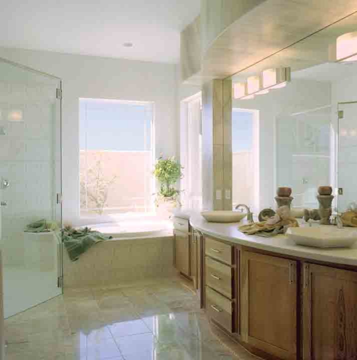 Example of a mid-sized transitional master brown tile and ceramic tile porcelain tile freestanding bathtub design in Seattle with recessed-panel cabinets, medium tone wood cabinets, granite countertops, a two-piece toilet and gray walls