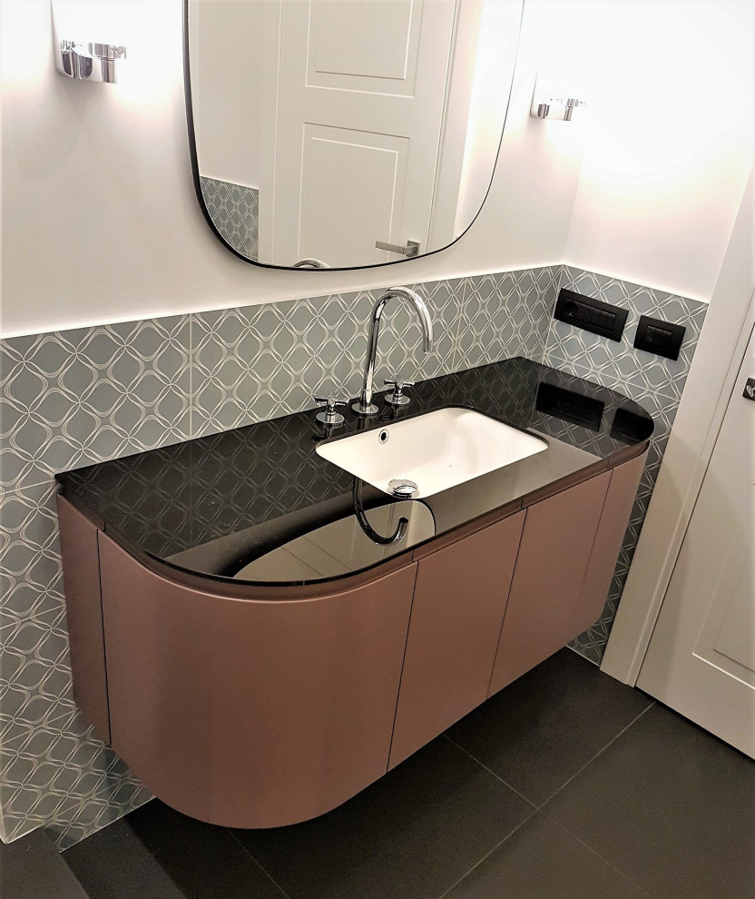 This is an example of a mid-sized contemporary bathroom in Rome with flat-panel cabinets, red cabinets, a curbless shower, a two-piece toilet, beige tile, ceramic tile, white walls, porcelain floors, a vessel sink, glass benchtops, black floor, black benchtops, a niche, a single vanity and a floating vanity.