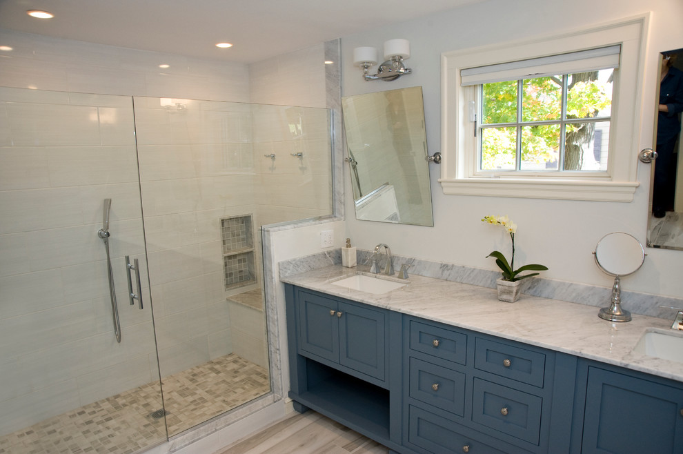 This is an example of a large transitional master bathroom in Boston with an undermount sink, shaker cabinets, blue cabinets, marble benchtops, multi-coloured tile and white walls.
