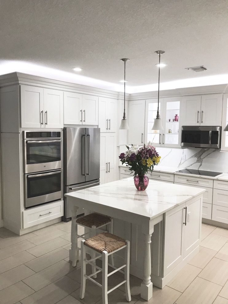Photo of a medium sized classic u-shaped kitchen/diner in Other with shaker cabinets, white cabinets, engineered stone countertops, multi-coloured splashback, engineered quartz splashback, stainless steel appliances, an island, multicoloured worktops and a belfast sink.
