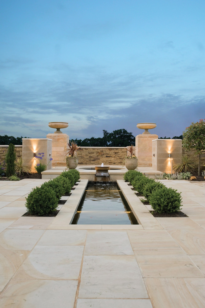 Inspiration for a mid-sized contemporary garden in Other with a water feature.