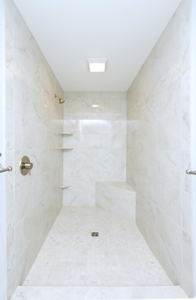 Example of a mid-sized transitional master white tile and stone tile porcelain tile and white floor corner bathtub design with shaker cabinets, white cabinets, a one-piece toilet, blue walls, an integrated sink, solid surface countertops, a hinged shower door and white countertops