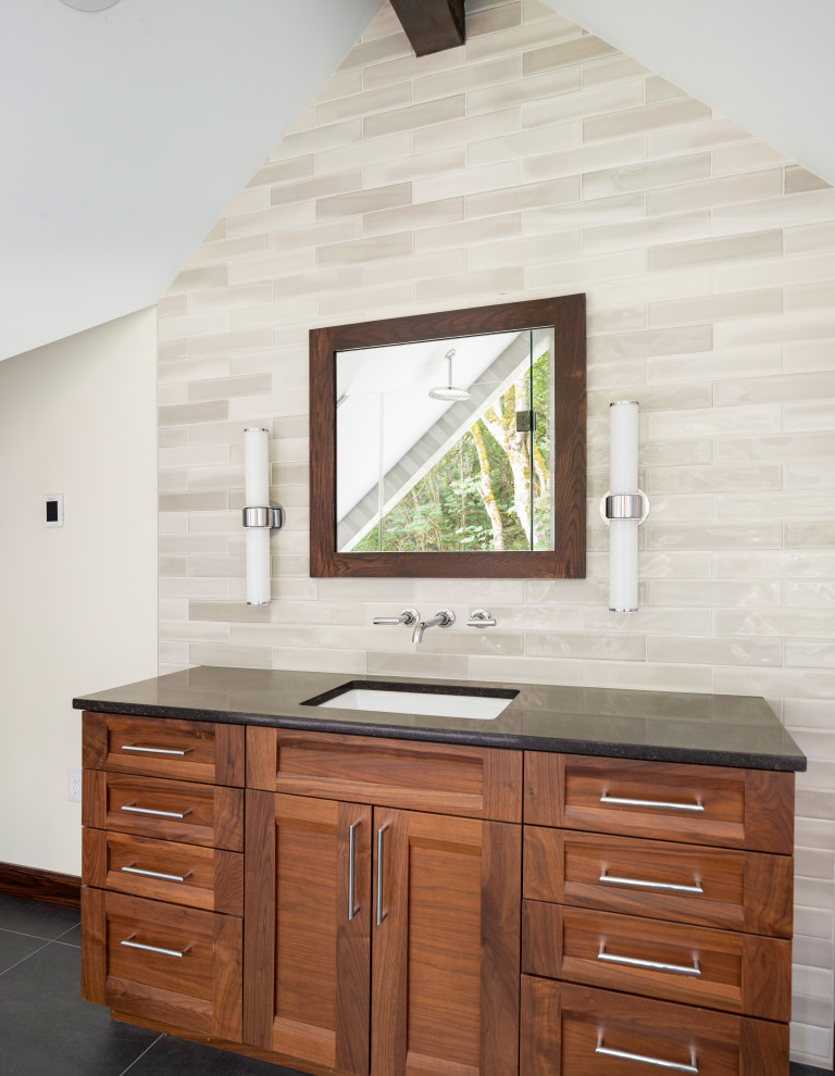 Mid-sized contemporary master bathroom in Seattle with recessed-panel cabinets, dark wood cabinets, a freestanding tub, a curbless shower, a wall-mount toilet, beige tile, ceramic tile, white walls, porcelain floors, an undermount sink, engineered quartz benchtops, black floor, a hinged shower door, black benchtops, a single vanity, a built-in vanity and vaulted.