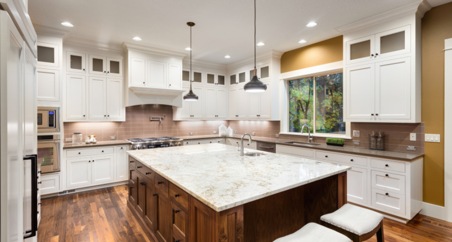 Inspiration for a large transitional u-shaped dark wood floor and brown floor kitchen remodel in Houston with an undermount sink, recessed-panel cabinets, white cabinets, granite countertops, brown backsplash, porcelain backsplash, paneled appliances, an island and brown countertops