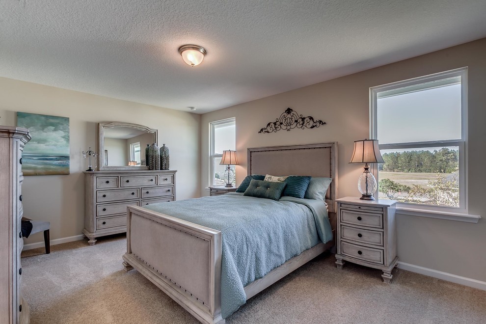 Design ideas for a mid-sized traditional master bedroom in Jacksonville with beige walls, carpet, no fireplace and grey floor.