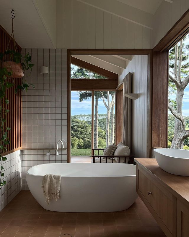 Inspiration for a rustic white tile terra-cotta tile, brown floor, single-sink and vaulted ceiling freestanding bathtub remodel in Other with furniture-like cabinets, light wood cabinets, a vessel sink, wood countertops, brown countertops and a floating vanity
