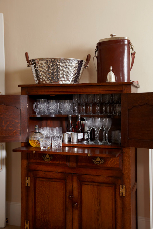Mid-sized traditional home bar in Surrey with carpet.