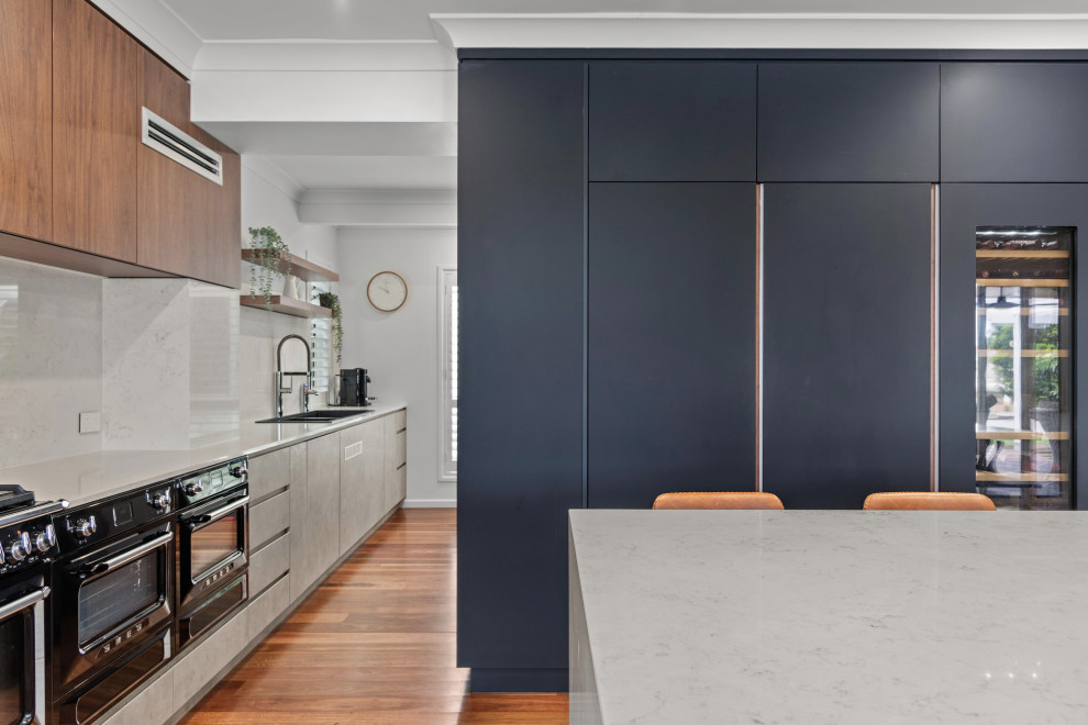 This is an example of a contemporary kitchen in Brisbane with black appliances.