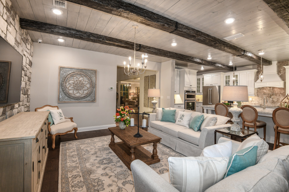 Design ideas for a mid-sized traditional open concept family room in Orlando with grey walls, medium hardwood floors, no fireplace, a wall-mounted tv and brown floor.