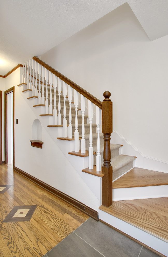 Design ideas for a small traditional carpeted straight staircase in Seattle with wood risers.