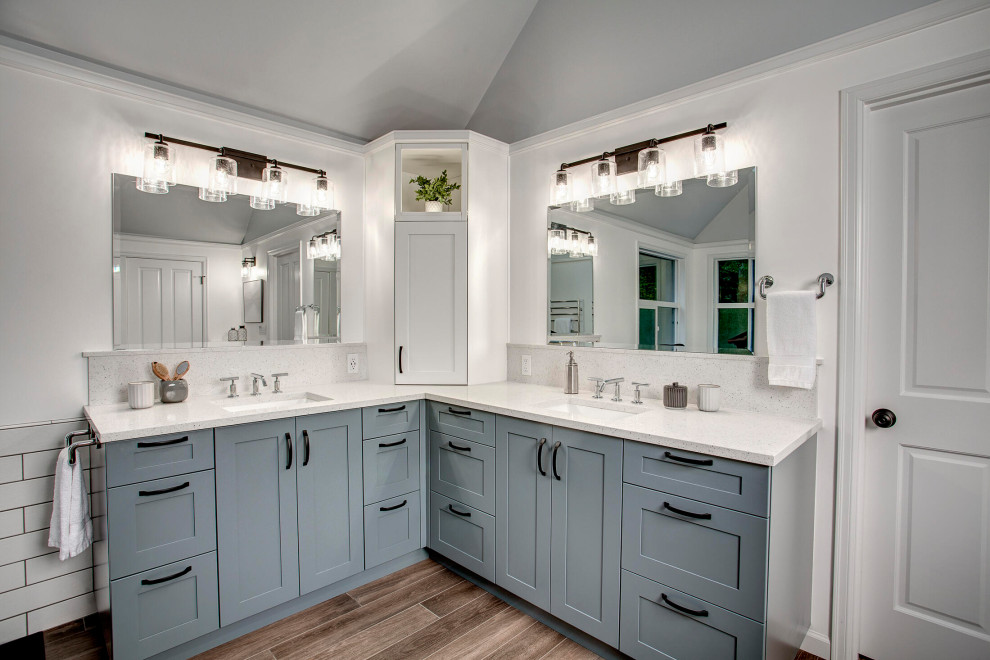 Photo of a large classic ensuite bathroom in Seattle with shaker cabinets, grey cabinets, a freestanding bath, a walk-in shower, a two-piece toilet, white tiles, ceramic tiles, white walls, porcelain flooring, a submerged sink, engineered stone worktops, brown floors, an open shower, white worktops, a shower bench, double sinks, a built in vanity unit and a vaulted ceiling.