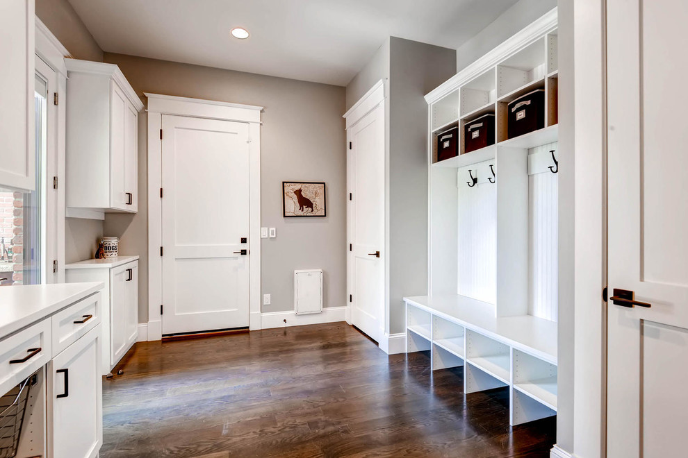 Inspiration for a mid-sized transitional dark wood floor and brown floor mudroom remodel in Cedar Rapids with beige walls and a white front door