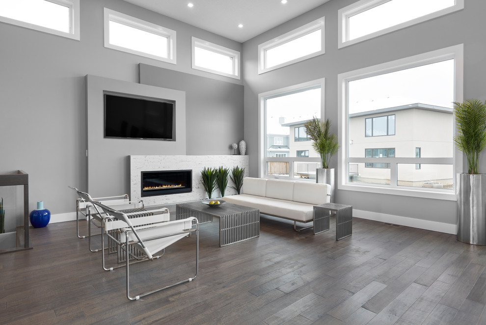 Inspiration for a mid-sized contemporary open concept living room in Edmonton with grey walls, medium hardwood floors, a ribbon fireplace, a tile fireplace surround, a built-in media wall and brown floor.