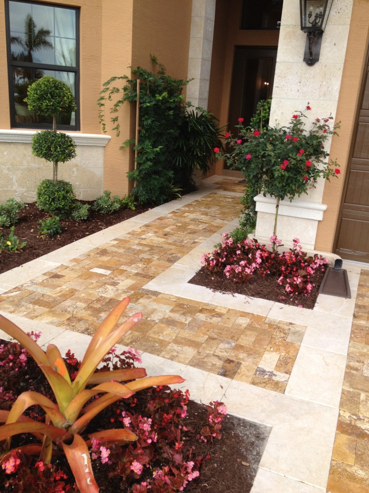 Example of a large transitional travertine floor front door design in Miami with beige walls and a dark wood front door