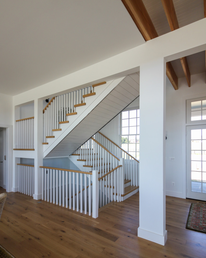 Medium sized rural wood u-shaped wood railing staircase in DC Metro with wood risers and tongue and groove walls.