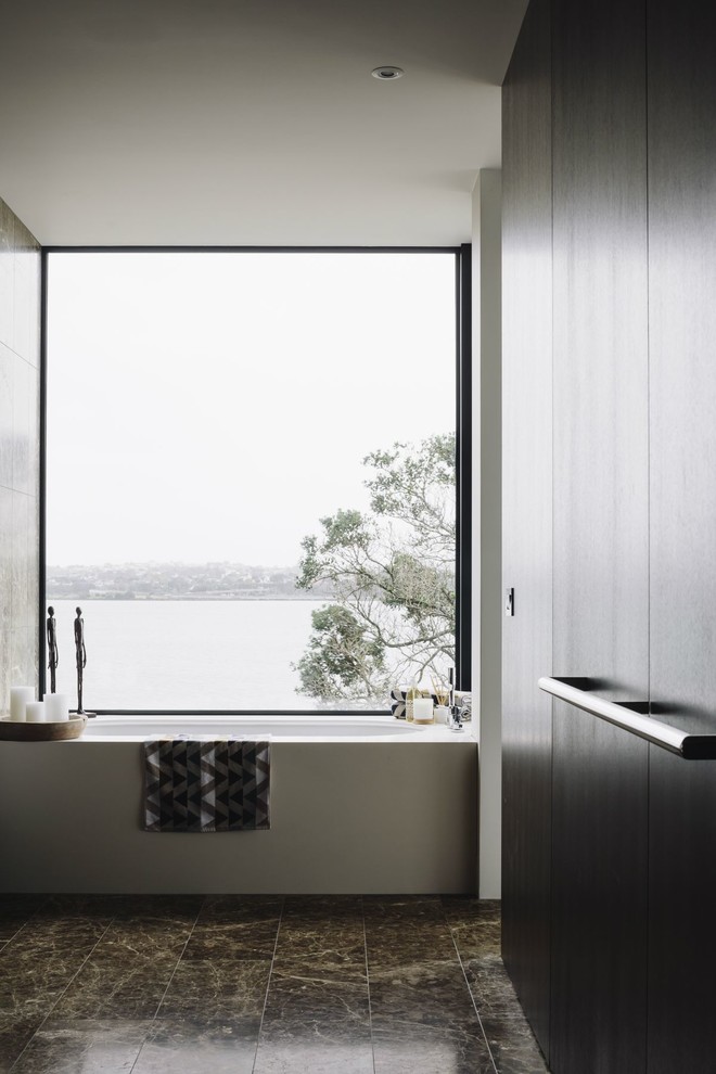 Design ideas for a contemporary master bathroom in Auckland with flat-panel cabinets, dark wood cabinets, an alcove tub, white walls and brown floor.