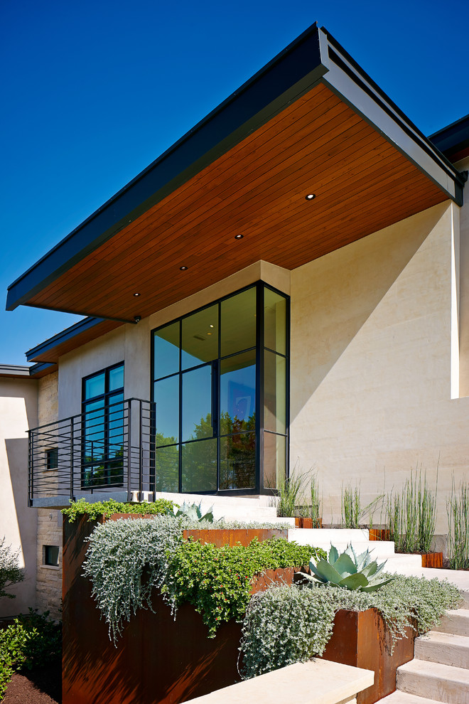 This is an example of a contemporary beige exterior in Austin.