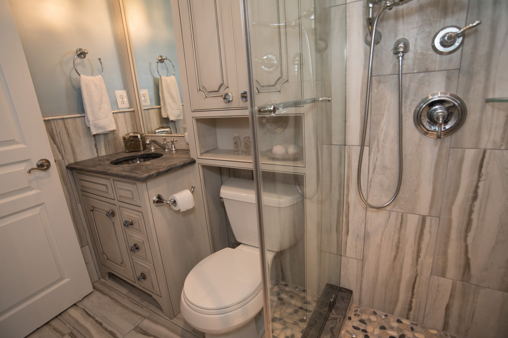 Design ideas for a mid-sized traditional 3/4 bathroom in DC Metro with raised-panel cabinets, grey cabinets, an open shower, gray tile, stone slab, blue walls, ceramic floors, granite benchtops, grey floor, an open shower and grey benchtops.