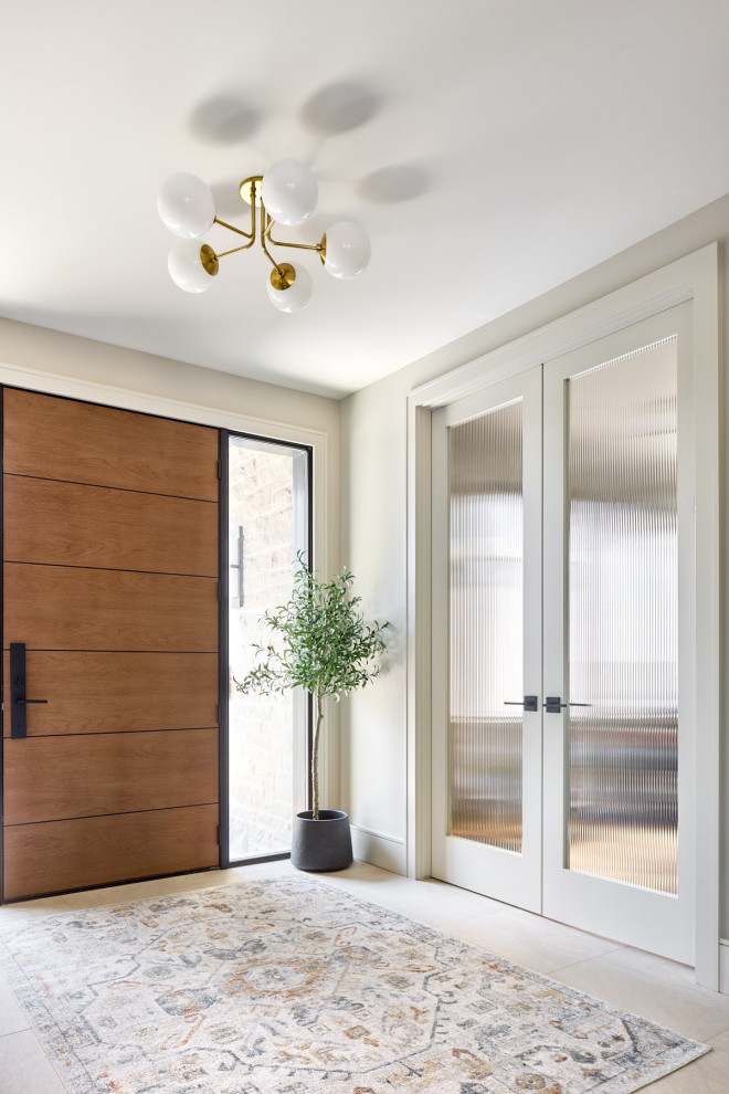 Foyer - mid-sized transitional porcelain tile and gray floor foyer idea with beige walls and a medium wood front door