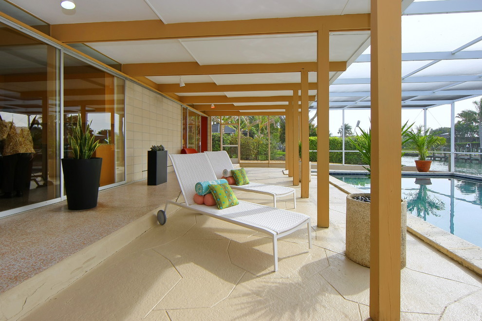 This is an example of a contemporary patio in Other with a roof extension.