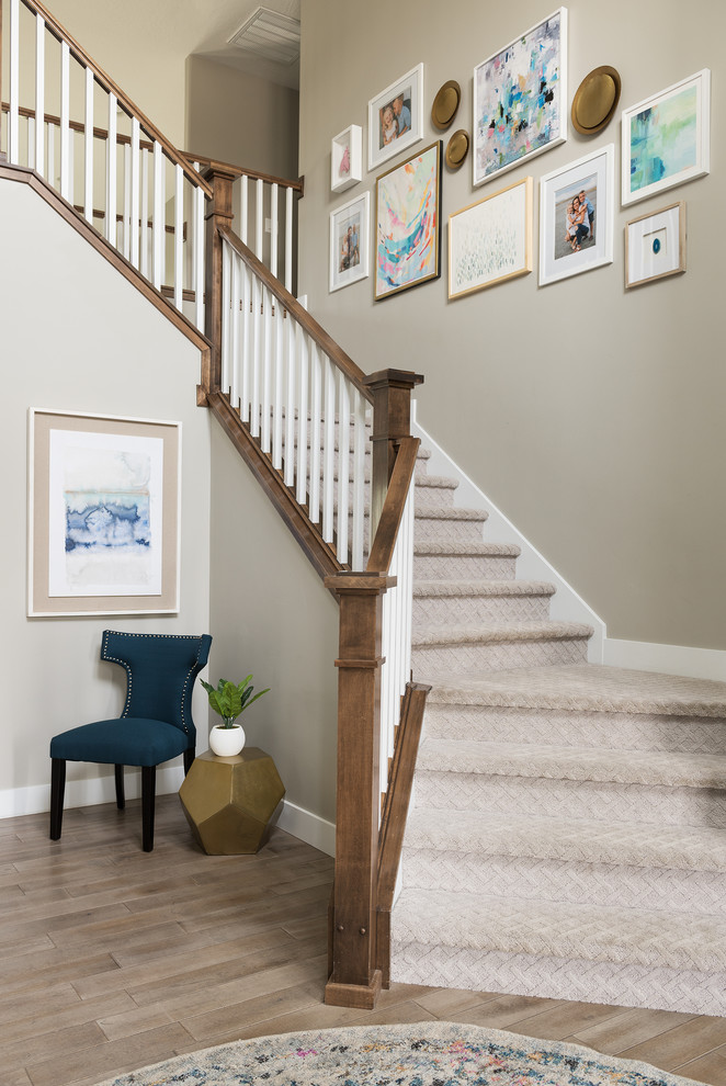 Beach style carpeted staircase in Denver with carpet risers and wood railing.
