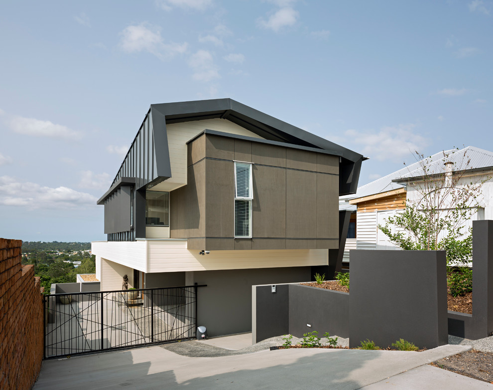 Inspiration for a contemporary two-storey brown exterior in Brisbane with wood siding.