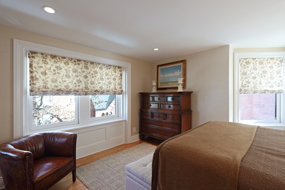 Mid-sized country master bedroom in New York with beige walls, light hardwood floors and no fireplace.