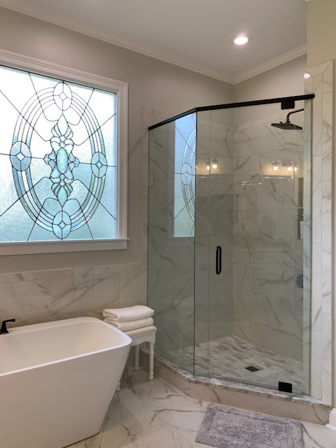 Mid-sized transitional master white tile porcelain tile, white floor and double-sink freestanding bathtub photo with recessed-panel cabinets, white cabinets, a two-piece toilet, gray walls, an undermount sink, granite countertops, a hinged shower door, beige countertops and a built-in vanity