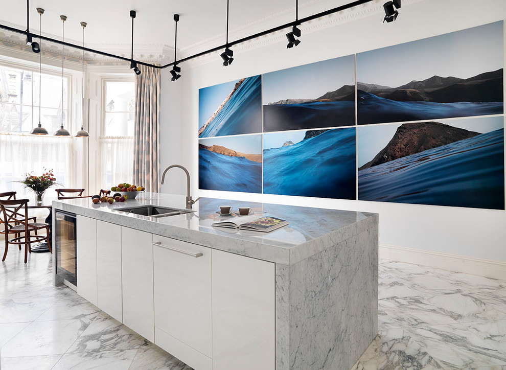 Inspiration for an expansive contemporary galley open plan kitchen in London with a farmhouse sink, flat-panel cabinets, white cabinets, marble benchtops, panelled appliances, marble floors and with island.