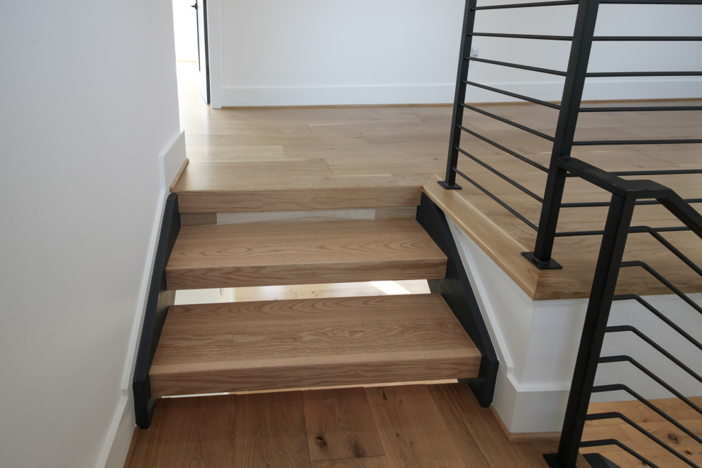 This is an example of a medium sized contemporary wood straight metal railing staircase in DC Metro.