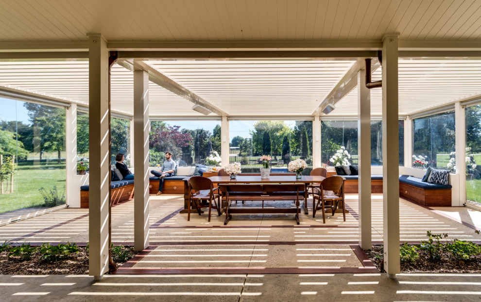Design ideas for an expansive country backyard patio in Napier-Hastings with a roof extension.