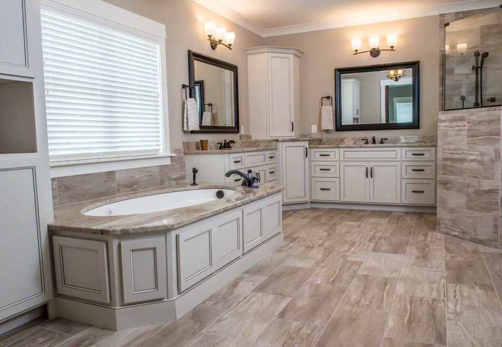 Large transitional master brown tile and porcelain tile porcelain tile and brown floor corner shower photo in Phoenix with recessed-panel cabinets, beige cabinets, an undermount tub, beige walls, an undermount sink and granite countertops