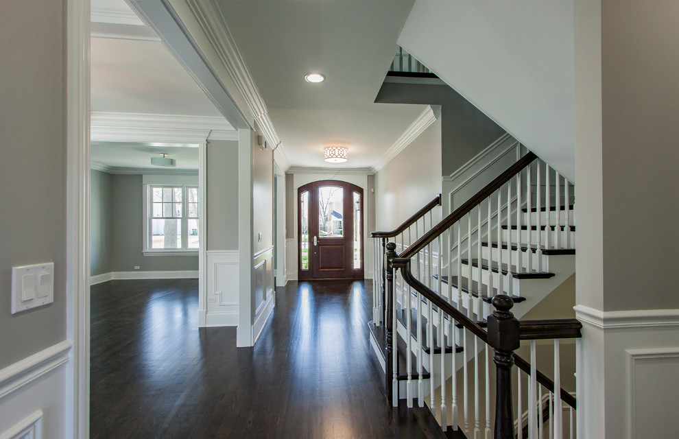 Mid-sized transitional dark wood floor foyer photo in Chicago with gray walls and a medium wood front door