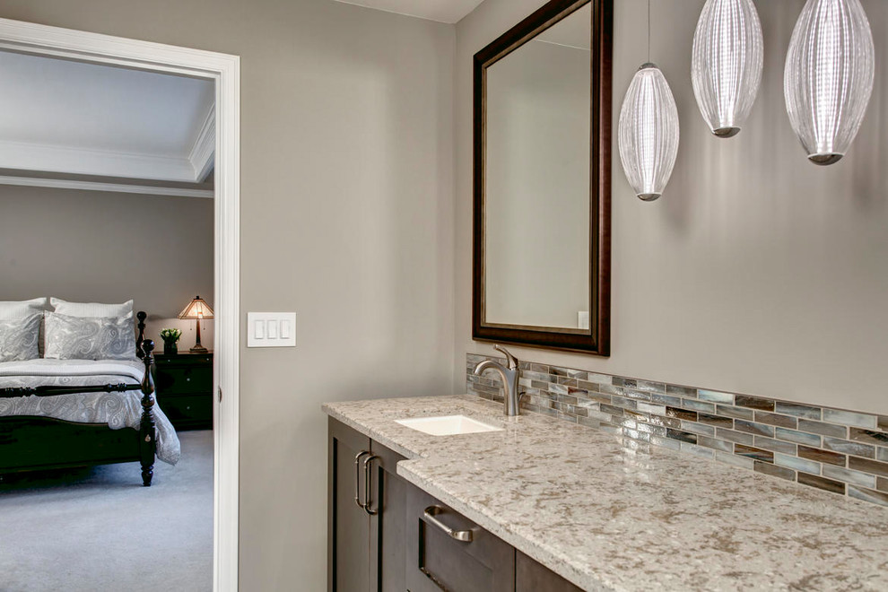 Large transitional master multicolored tile and matchstick tile pebble tile floor freestanding bathtub photo in Seattle with shaker cabinets, dark wood cabinets, a two-piece toilet, beige walls, an undermount sink and quartz countertops