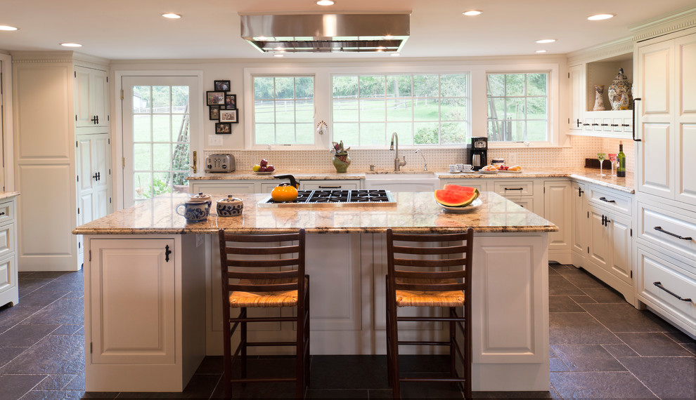 Photo of a l-shaped kitchen in Baltimore with raised-panel cabinets and white cabinets.