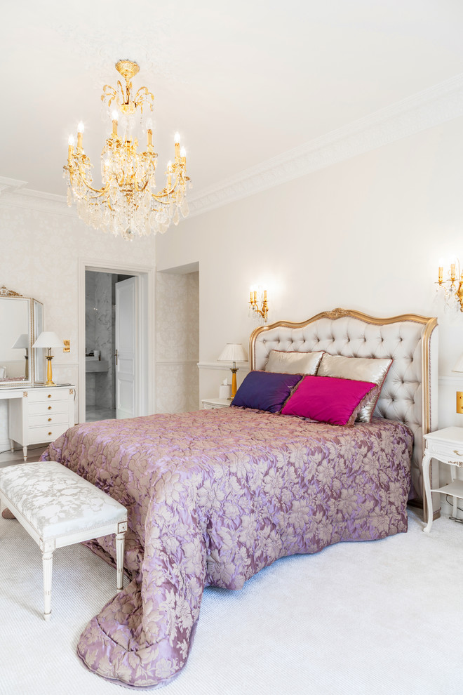 Mid-sized traditional master bedroom in Paris with white walls and carpet.