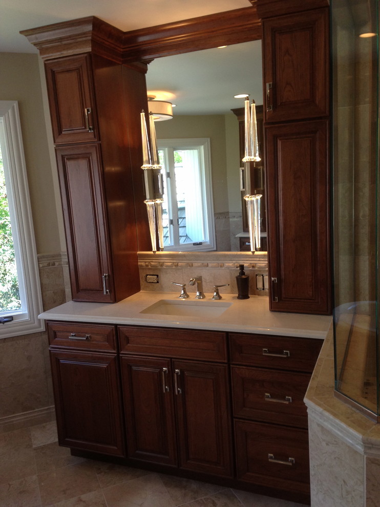 Inspiration for a large transitional master beige tile and stone tile marble floor freestanding bathtub remodel in Chicago with raised-panel cabinets, medium tone wood cabinets, quartz countertops, a two-piece toilet, an undermount sink and beige walls