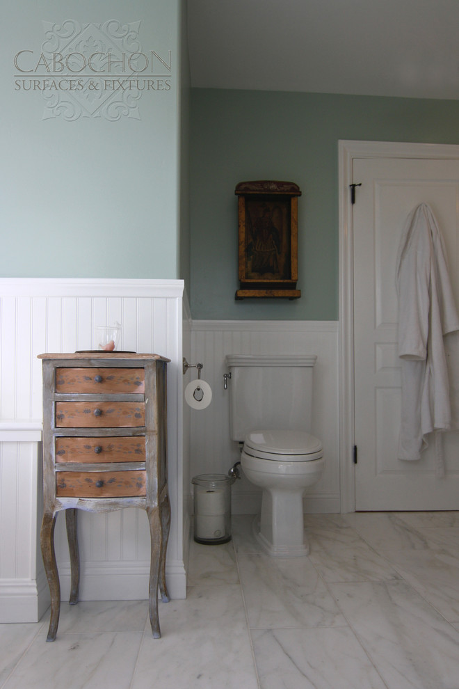 Inspiration for a mid-sized beach style master bathroom in San Diego with a pedestal sink, a claw-foot tub, an alcove shower, a one-piece toilet, furniture-like cabinets, turquoise cabinets, white tile, stone tile, green walls and marble floors.