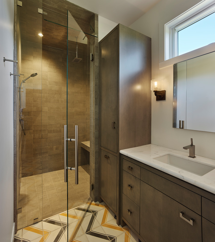 This is an example of a country 3/4 bathroom in San Francisco with flat-panel cabinets, brown cabinets, a curbless shower, brown tile, white walls, an undermount sink, multi-coloured floor and a hinged shower door.
