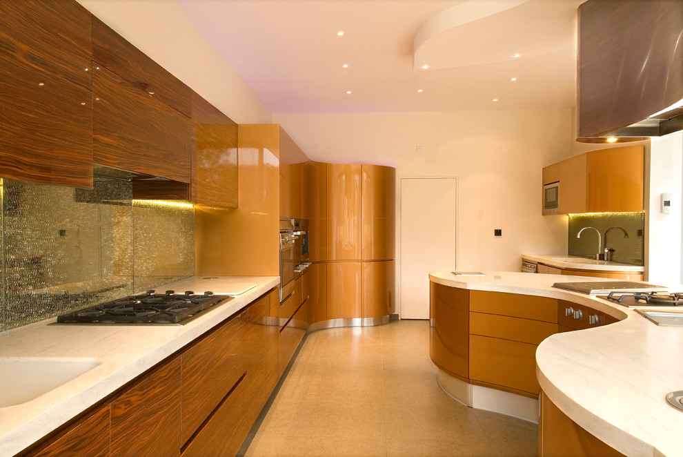 This is an example of a large contemporary l-shaped kitchen/diner in London with an integrated sink, flat-panel cabinets, brown cabinets, composite countertops, beige splashback, glass sheet splashback, stainless steel appliances, travertine flooring and an island.