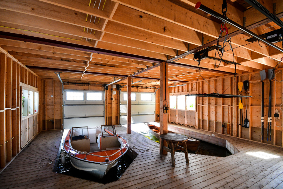 This is an example of a beach style two-car boathouse in Other.