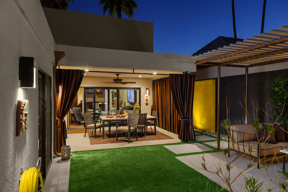 Photo of a mid-sized contemporary backyard patio in Phoenix with a pergola.
