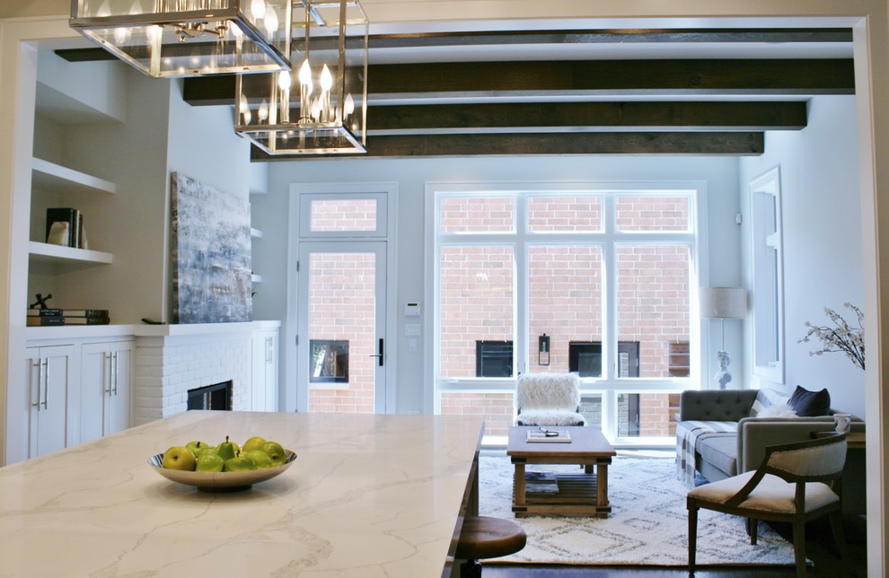 Inspiration for a huge transitional galley dark wood floor and brown floor open concept kitchen remodel in Chicago with an undermount sink, shaker cabinets, white cabinets, quartz countertops, white backsplash, subway tile backsplash, stainless steel appliances and an island