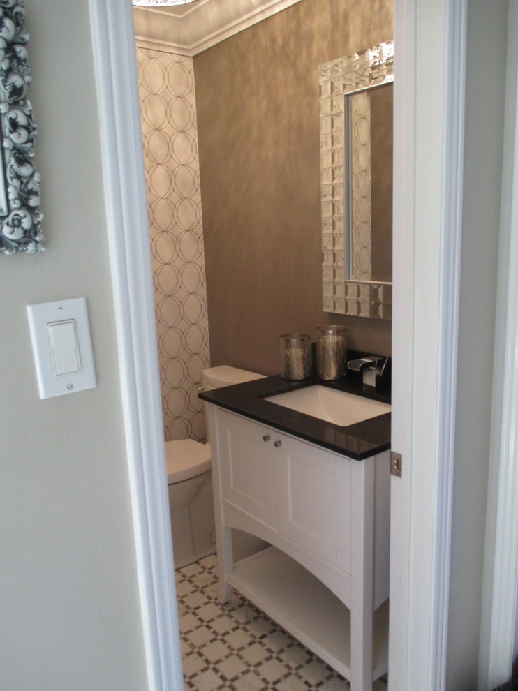 Design ideas for a small contemporary powder room in Toronto with recessed-panel cabinets, white cabinets, brown walls and mosaic tile floors.