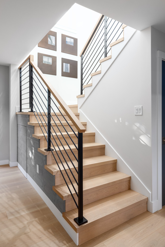 Staircase - large contemporary wooden u-shaped metal railing staircase idea in San Francisco with wooden risers