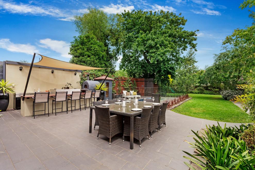 Design ideas for a traditional backyard patio in Melbourne with concrete pavers and no cover.