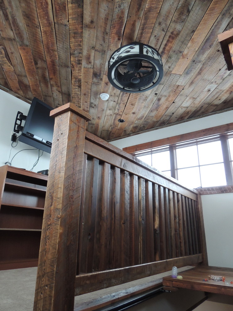Example of a mid-sized mountain style dark wood floor staircase design with no fireplace and a standard ceiling