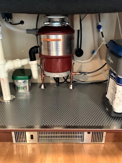 Inspiration for a mid-sized transitional u-shaped light wood floor and brown floor enclosed kitchen remodel in Boston with an undermount sink, recessed-panel cabinets, brown cabinets, granite countertops, beige backsplash, stainless steel appliances, no island and beige countertops